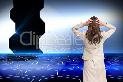 Composite image of businesswoman with hands on head standing bac