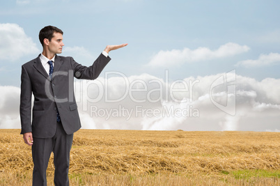 Composite image of stern businessman presenting