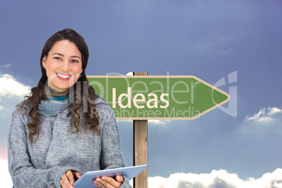 Composite image of smiling model wearing winter clothes holding