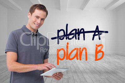 Composite image of smiling young man with tablet computer