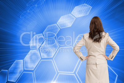 Composite image of businesswoman standing back to camera