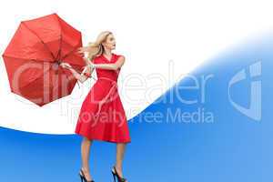 Composite image of elegant blonde holding umbrella