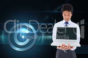 Composite image of businessman showing a laptop