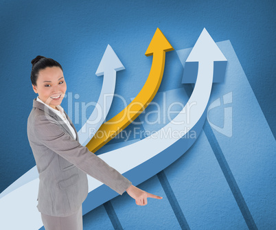 Composite image of smiling asian businesswoman pointing