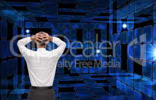 Composite image of businessman standing back to camera hands on