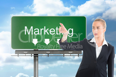 Composite image of businesswoman pointing somewhere