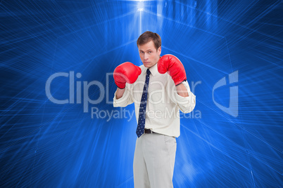 Composite image of businessman with his boxing gloves ready to f