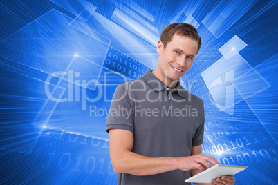 Composite image of smiling young man with tablet computer