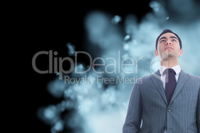 Composite image of unsmiling businessman standing