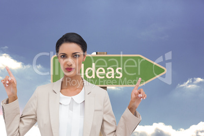 Composite image of serious businesswoman with hands up