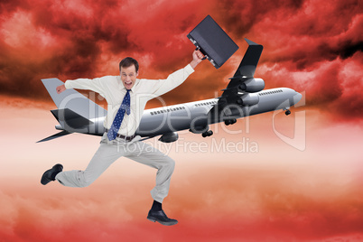 Composite image of cheerful jumping businessman with his suitcas