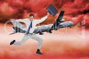 Composite image of cheerful jumping businessman with his suitcas