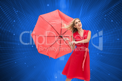 Composite image of elegant blonde holding umbrella