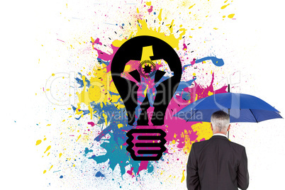 Composite image of businessman holding umbrella