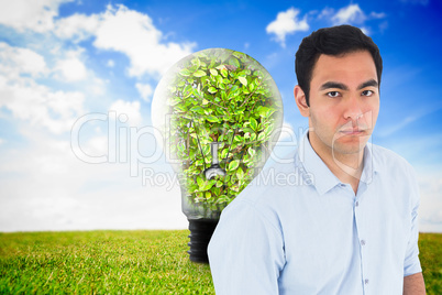 Composite image of unsmiling casual man standing