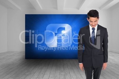 Composite image of smiling businessman looking down