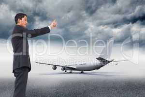 Composite image of serious asian businessman pointing