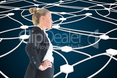 Composite image of businesswoman standing with hands on hips