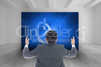 Composite image of businessman with arms raised