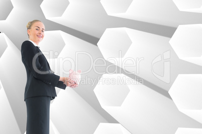 Composite image of businesswoman holding pink piggy bank