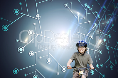 Composite image of little boy with his bike in a park