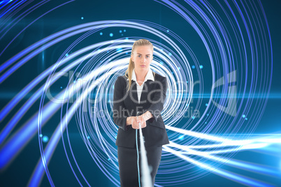 Composite image of businesswoman pulling a rope