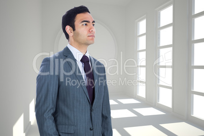 Composite image of unsmiling businessman standing