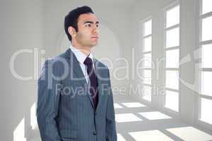 Composite image of unsmiling businessman standing