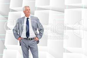 Composite image of man in a suit with his hands on his hips