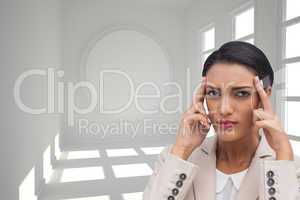 Composite image of young businesswoman putting her fingers on he