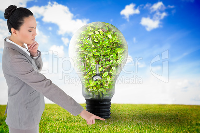 Composite image of unsmiling thinking asian businesswoman pointi