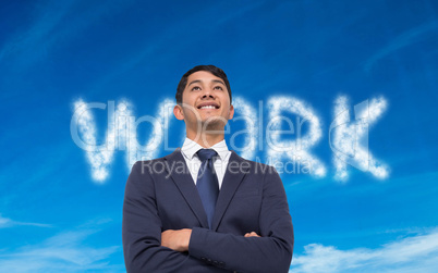 Composite image of smiling asian businessman with arms crossed