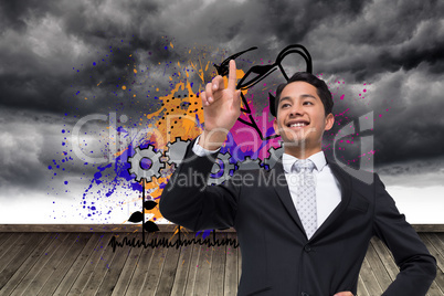 Composite image of smiling asian businessman pointing