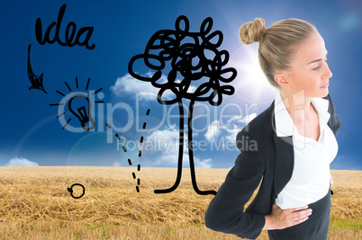 Composite image of businesswoman standing with hands on hips