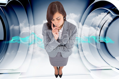 Composite image of worried businesswoman