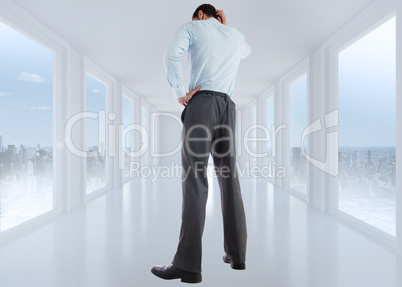 Composite image of thinking businessman with hand on head