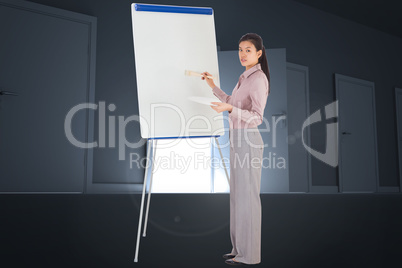 Composite image of businesswoman painting on an easel