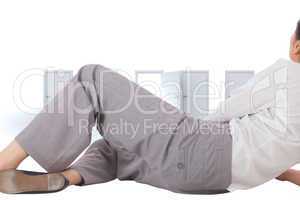 Composite image of relaxed businesswoman lying