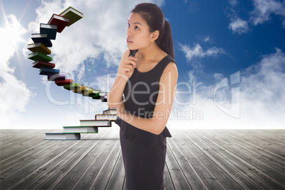 Composite image of thoughtful businesswoman