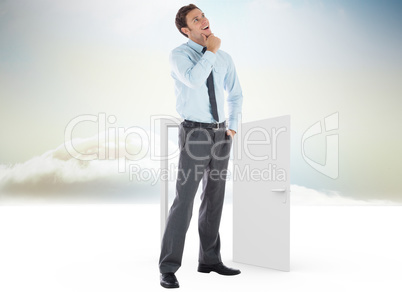 Composite image of thoughtful businessman with hand on chin