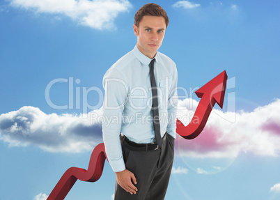 Composite image of serious businessman with hand in pocket