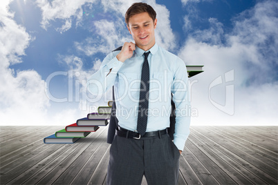 Composite image of smiling businessman holding his jacket