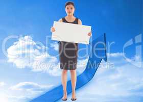 Composite image of businesswoman holding a placard