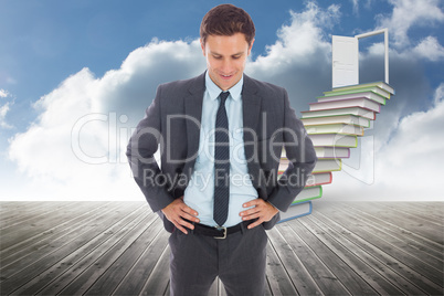 Composite image of cheerful businessman standing with hands on h