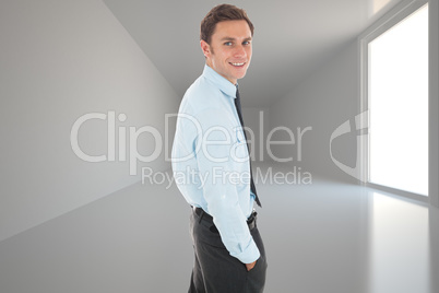 Composite image of happy businessman standing with hand in pocke