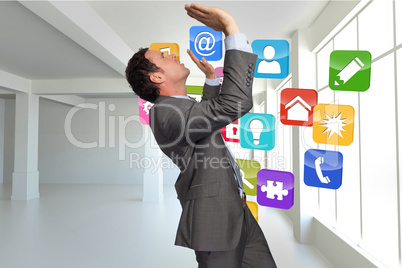 Composite image of businessman standing with arms pressing up