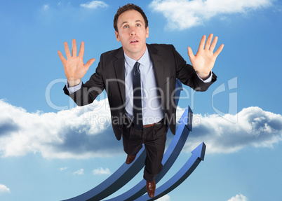 Composite image of businessman posing with arms raised