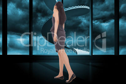 Composite image of asian businesswoman walking