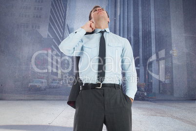 Composite image of serious businessman holding his jacket