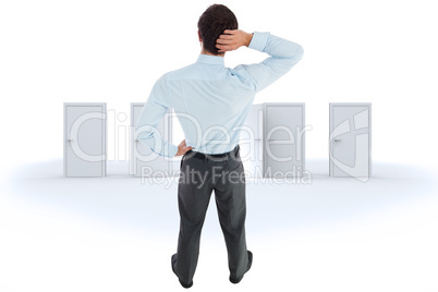 Composite image of thinking businessman scratching head